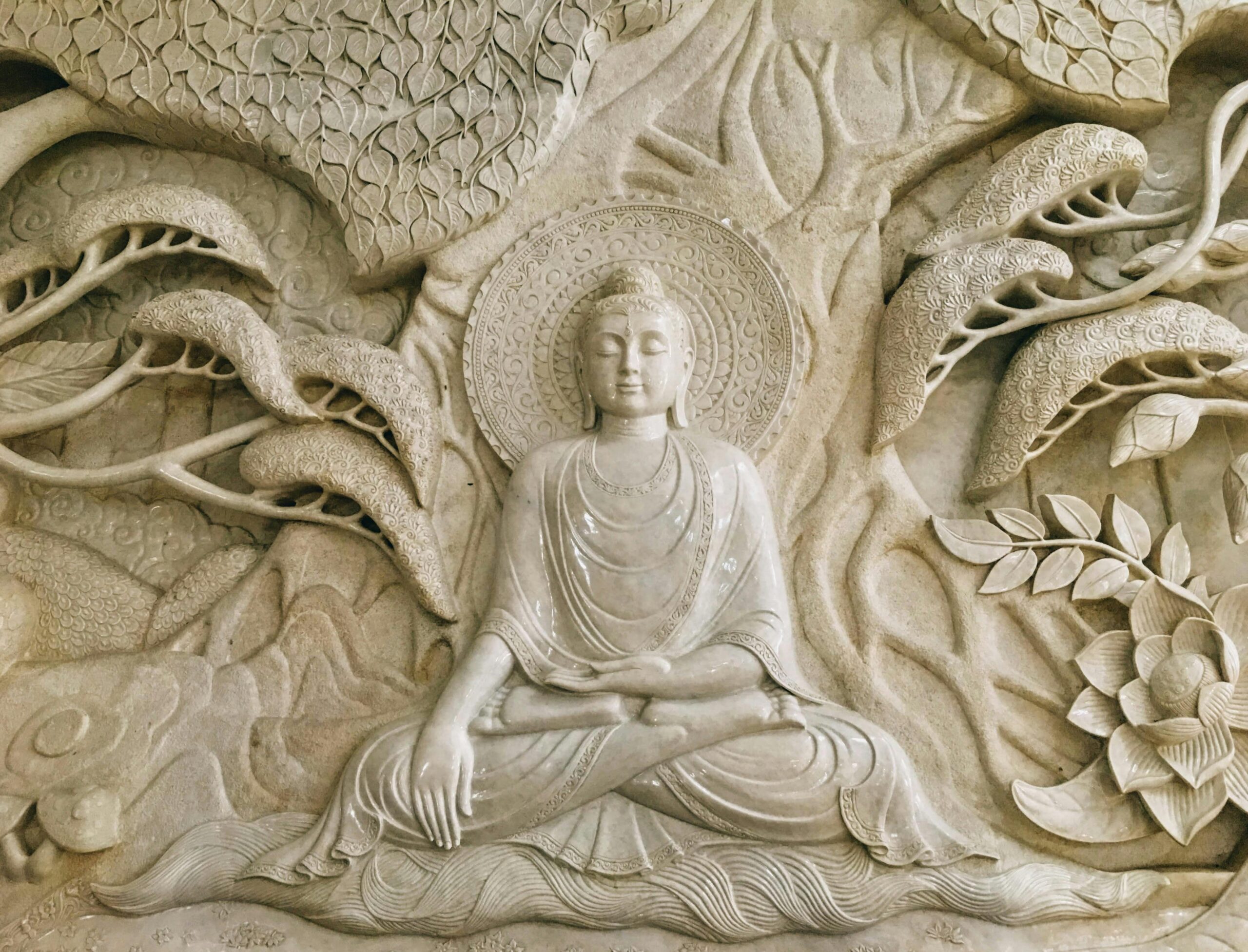 Detailed stone carving of Buddha in Myanmar, reflecting Buddhism's serenity and artistry.